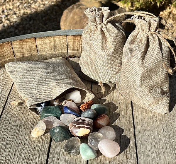 Image of three bags of crystals. One bag has crystals spilling out of it. 