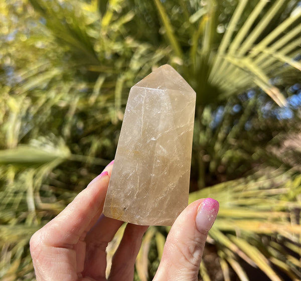 Image of a hand holding a limonite crystal tower.